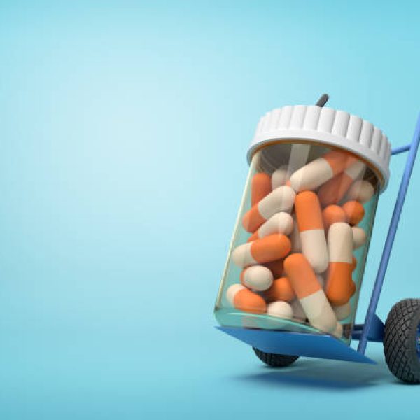 3d rendering of a plastic jar with medical pills on a hand truck on blue background. Medicine and health. Bottles and containers. Healthcare industry.